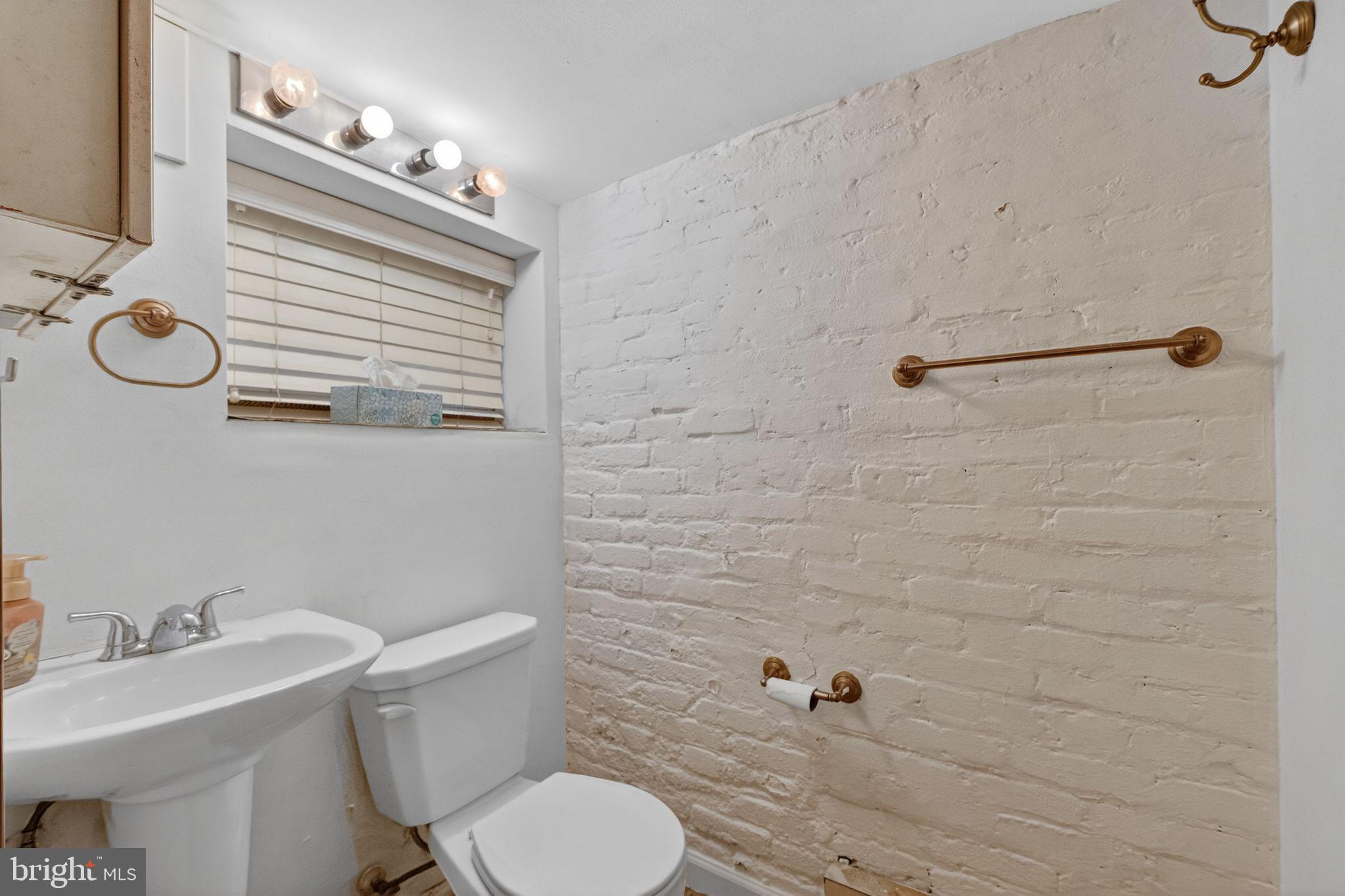 206 Cromwell Terrace Northeast Washington, DC 20002 - Photo 12 of 17 a bathroom with a toilet a sink and mirror