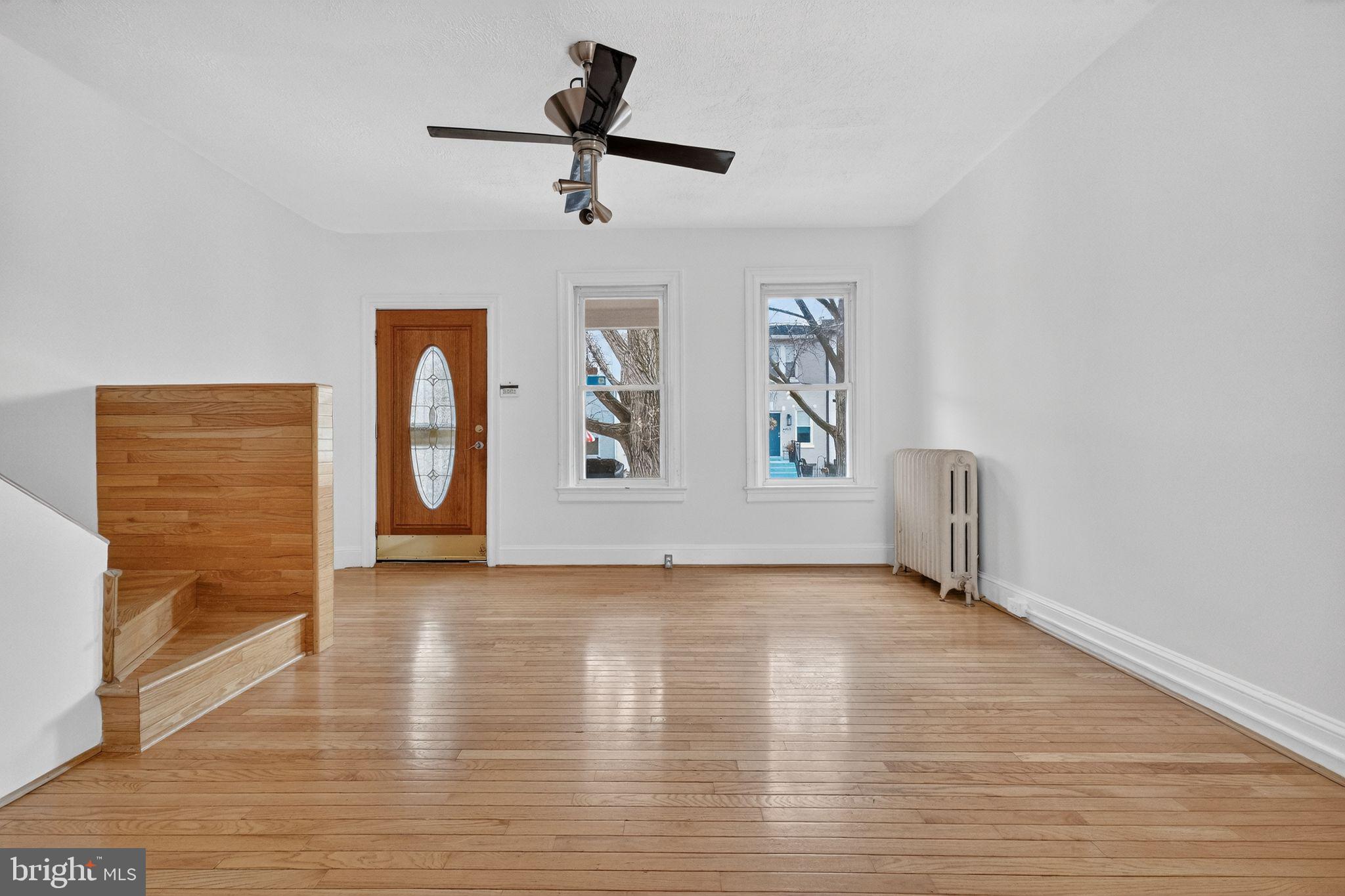 206 Cromwell Terrace Northeast Washington, DC 20002 - Photo 3 of 17 a view of an empty room with a window and wooden floor