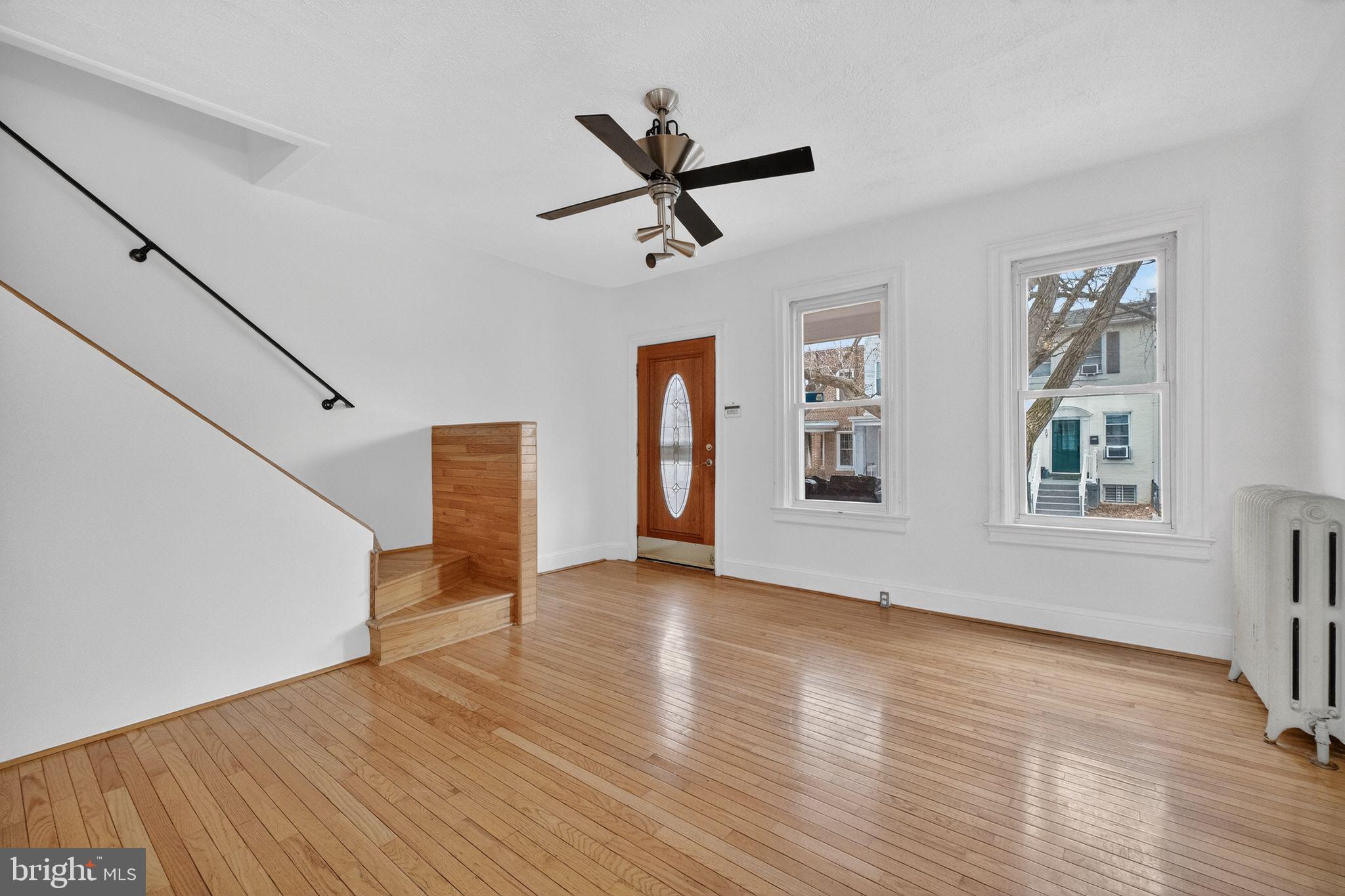 206 Cromwell Terrace Northeast Washington, DC 20002 - Photo 4 of 17 a view of empty room with wooden floor and window
