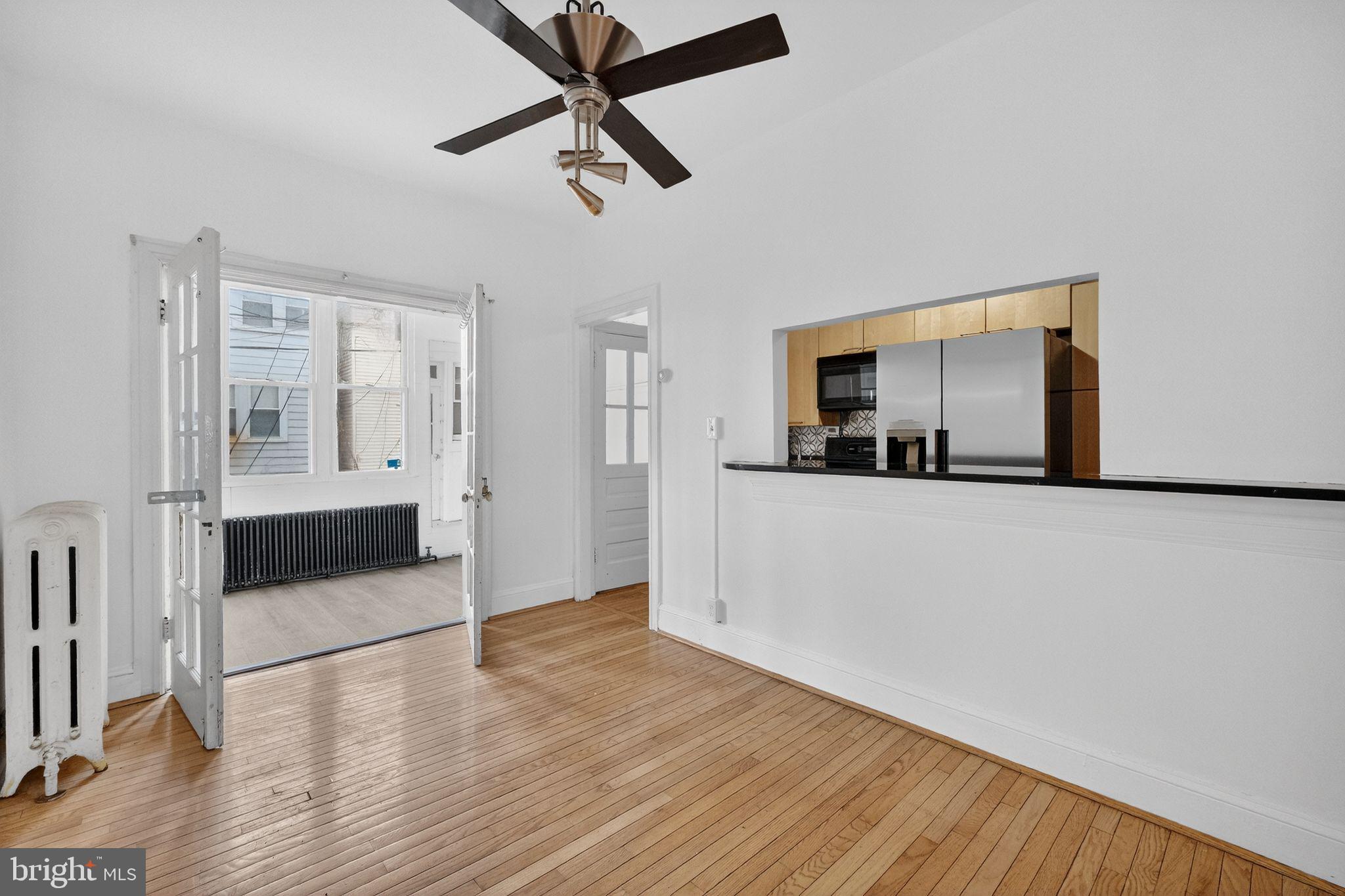 206 Cromwell Terrace Northeast Washington, DC 20002 - Photo 6 of 17 a view of a room with wooden floor and a ceiling fan