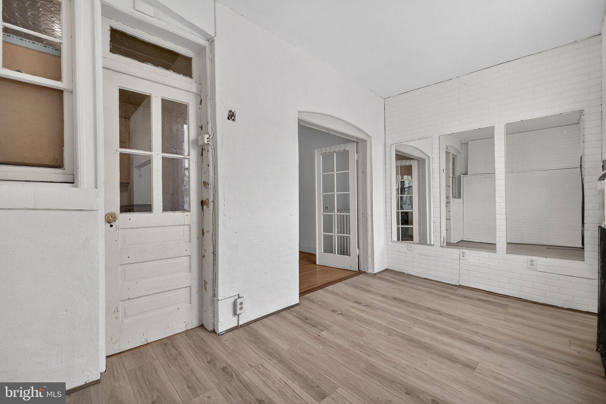 206 Cromwell Terrace Northeast Washington, DC 20002 - Photo 9 of 17 an empty room with wooden floor and windows