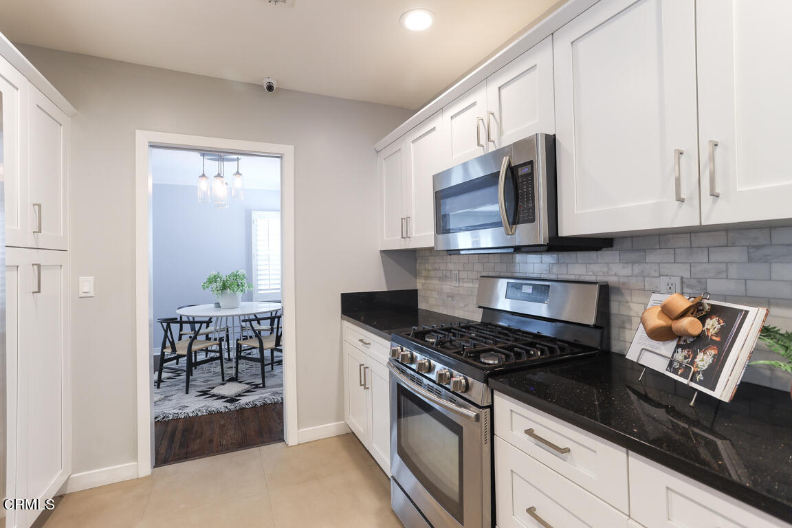 419 Cambridge Drive Burbank, CA 91504 - Photo 13 of 38 a kitchen with stainless steel appliances granite countertop a stove a microwave and a refrigerator