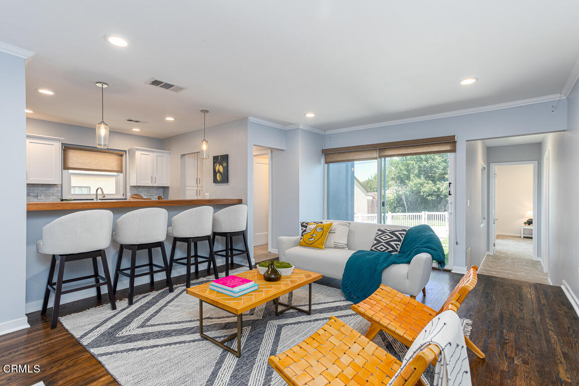419 Cambridge Drive Burbank, CA 91504 - Photo 17 of 38 a living room with furniture and a dining table with wooden floor