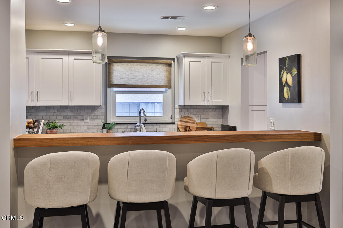 419 Cambridge Drive Burbank, CA 91504 - Photo 19 of 38 a kitchen with granite countertop a table chairs stove microwave and sink