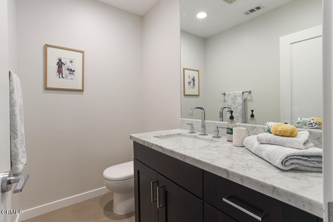 419 Cambridge Drive Burbank, CA 91504 - Photo 20 of 38 a bathroom with a granite countertop toilet sink and mirror