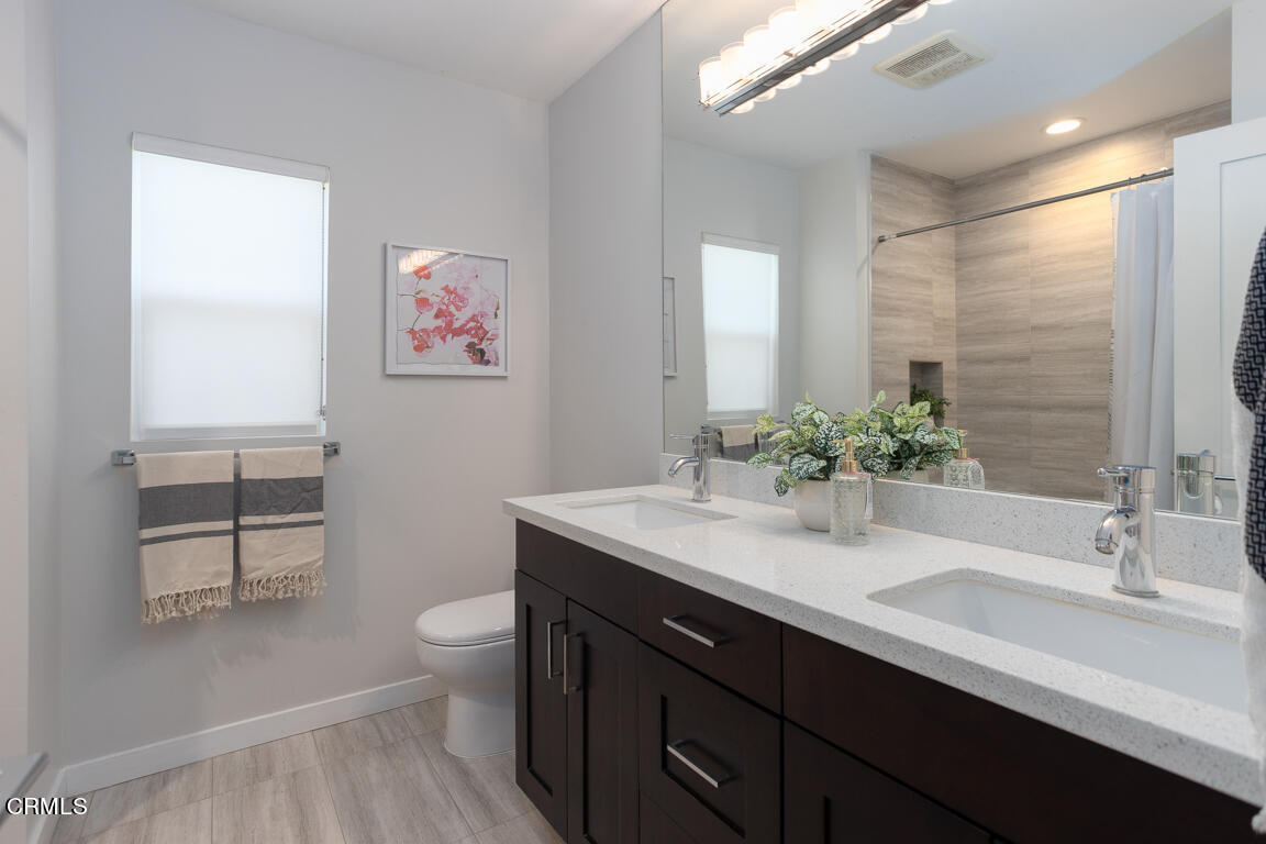 419 Cambridge Drive Burbank, CA 91504 - Photo 25 of 38 a bathroom with a sink a toilet and a large mirror