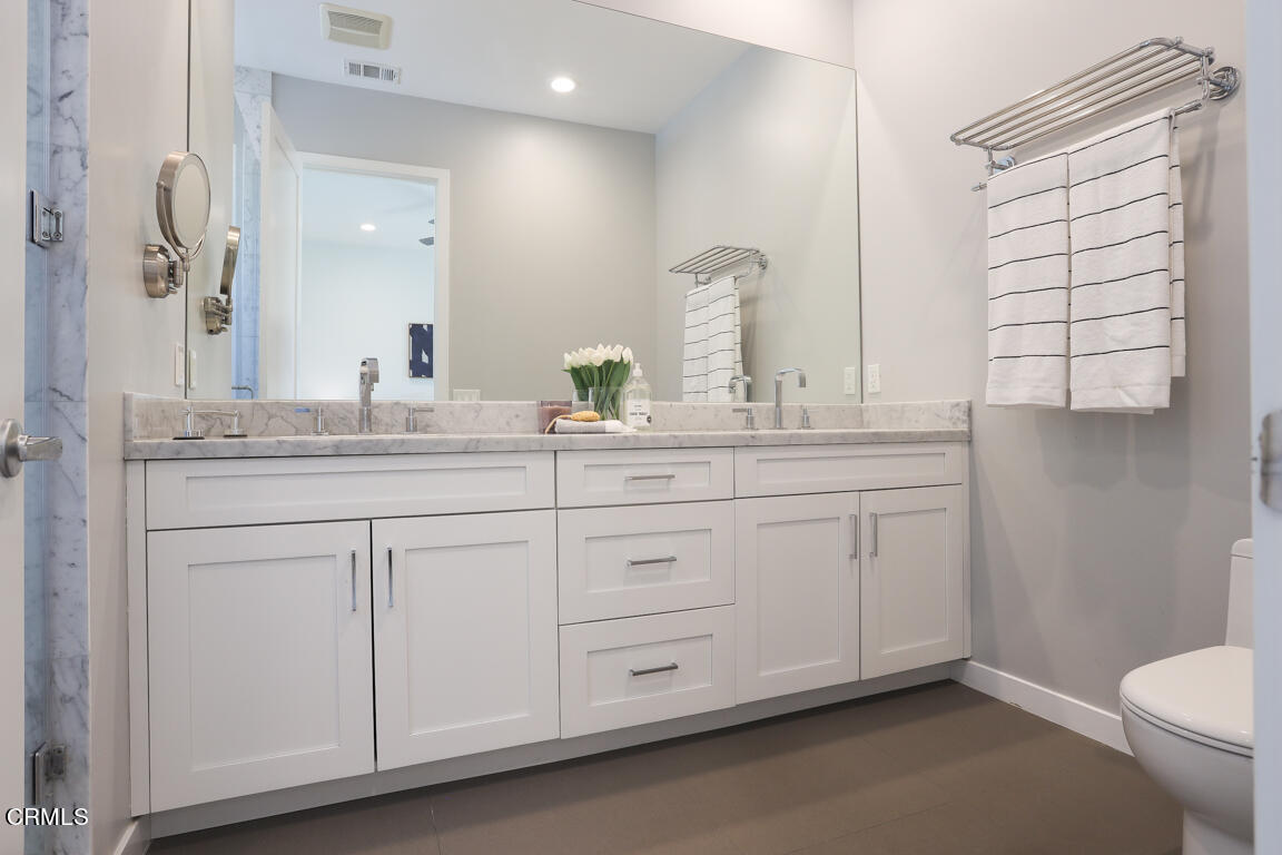 419 Cambridge Drive Burbank, CA 91504 - Photo 30 of 38 a bathroom with a double vanity sink and a mirror