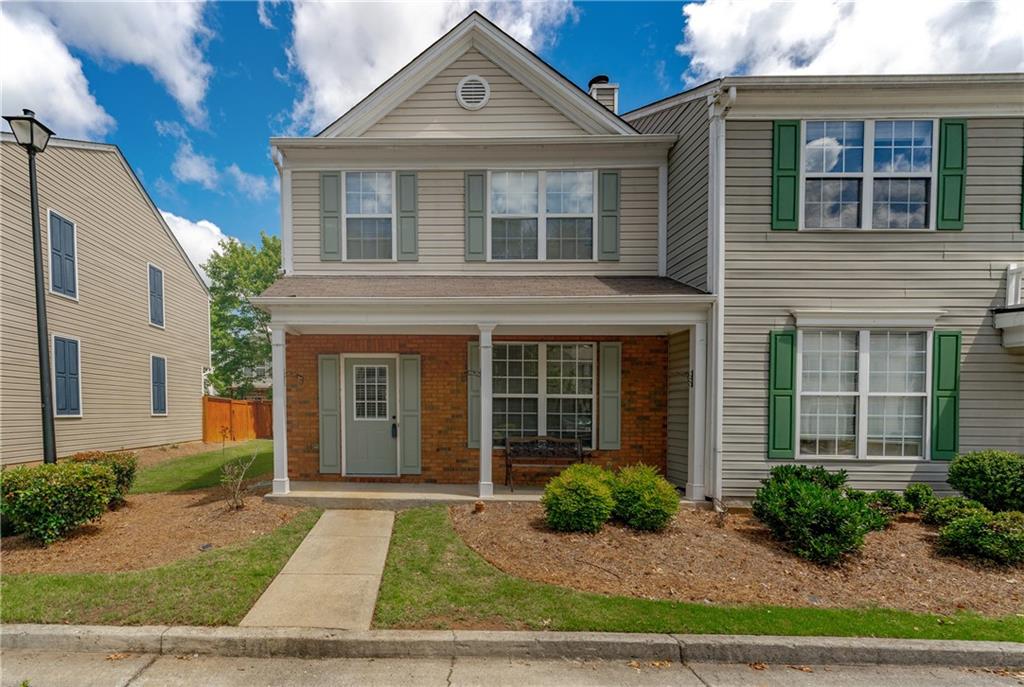 13300 Morris Road, Unit 77 Milton, GA 30004 - Photo 1 of 1 a front view of a house with garden