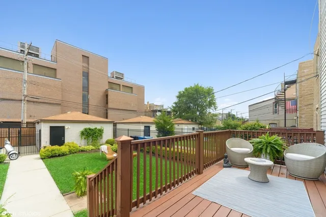 a view of a building with sitting area and garden
