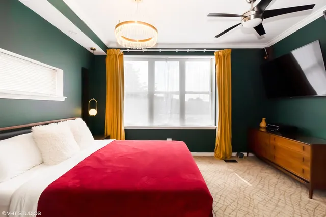 a bed room with a bed and a large window