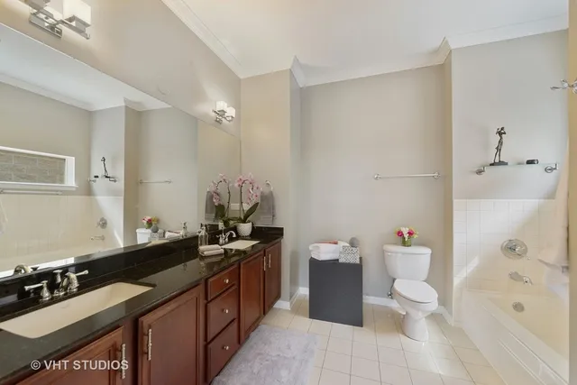 a spacious bathroom with a sink toilet and shower