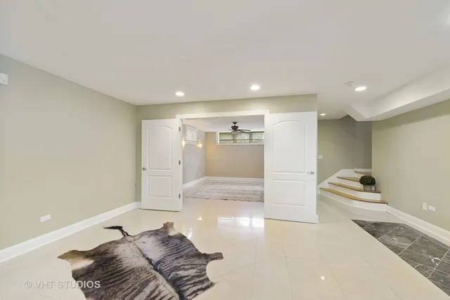 a living room with a couch and chandelier