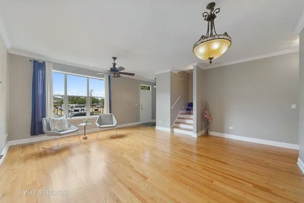 a view of a room with wooden floor and a window