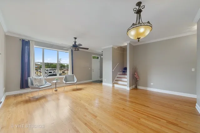 a view of a room with wooden floor and a window