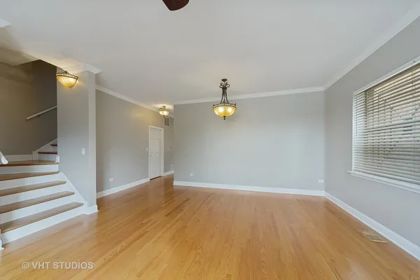 a view of wooden floor and windows in a room