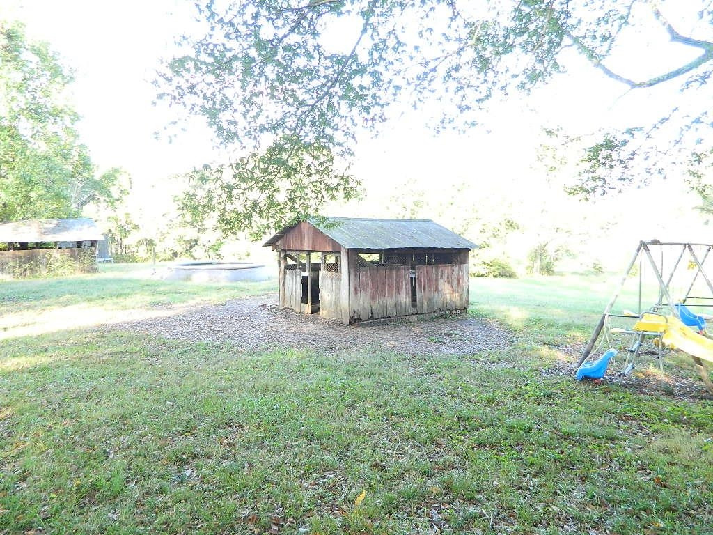 1180 Bennetts Road Huntingdon, TN 38344 - Photo 15 of 19 a view of a house with a yard and a large tree