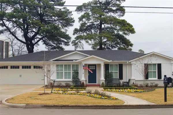 a front view of a house with swimming pool and porch