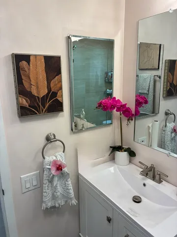 a bathroom with a sink vanity and a mirror