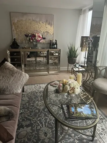 a living room with furniture and flowers
