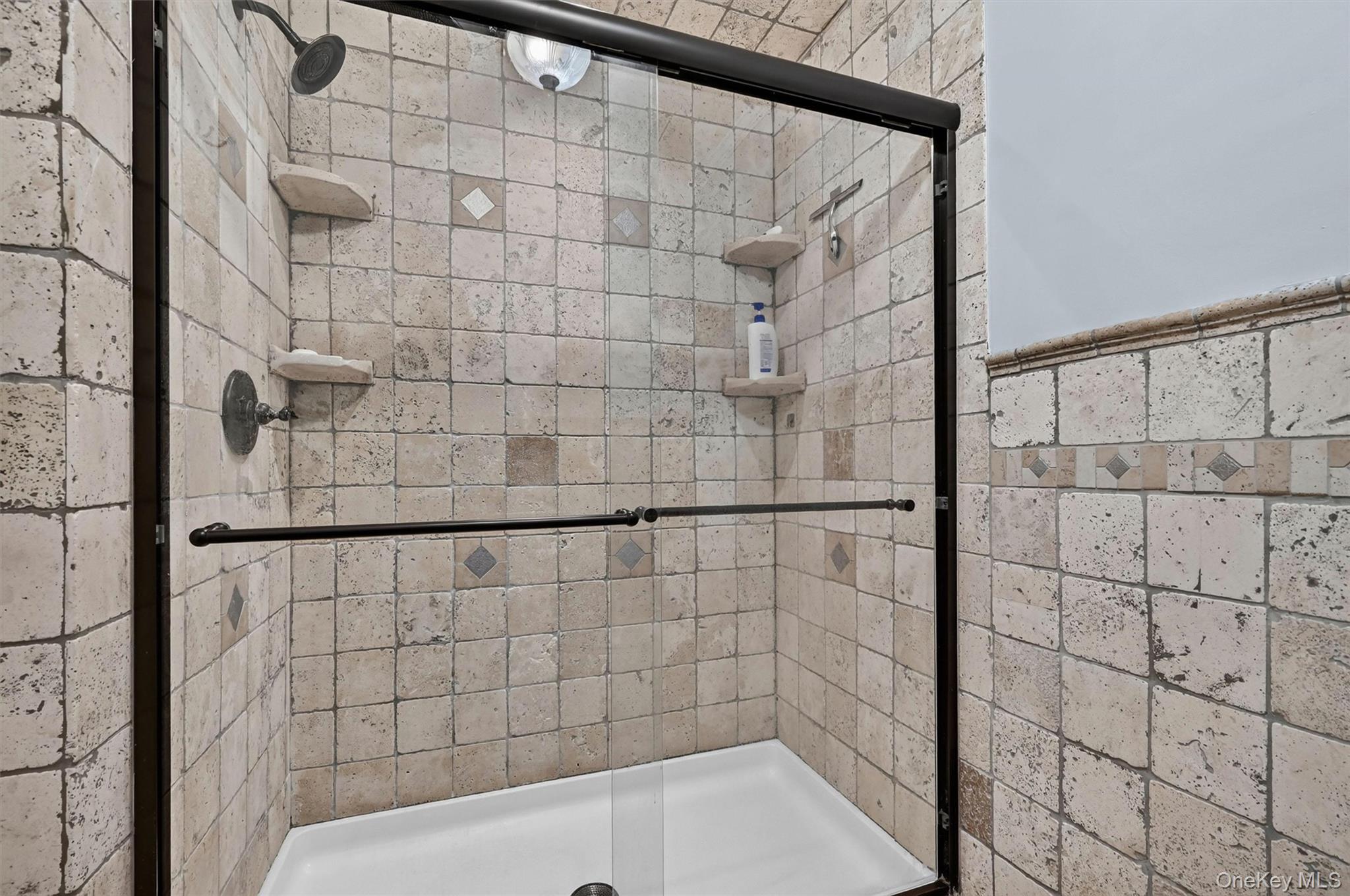 5 Hedges Road Warwick, NY 10990 - Photo 28 of 48 A tiled walk-in shower with glass doors adds function and timeless appeal to the updated primary bath.