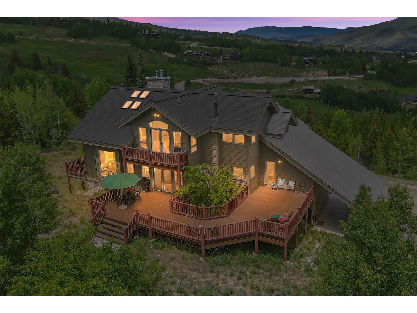 1746 South Ruby Road Silverthorne, CO 80498 - Photo 2 of 50 Back house at dusk with a wooden deck