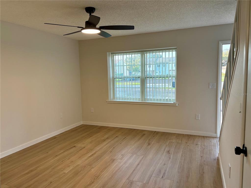 1455 Ridge Lake Court Lakeland, FL 33801 - Photo 4 of 15 a view of an empty room with wooden floor and a window