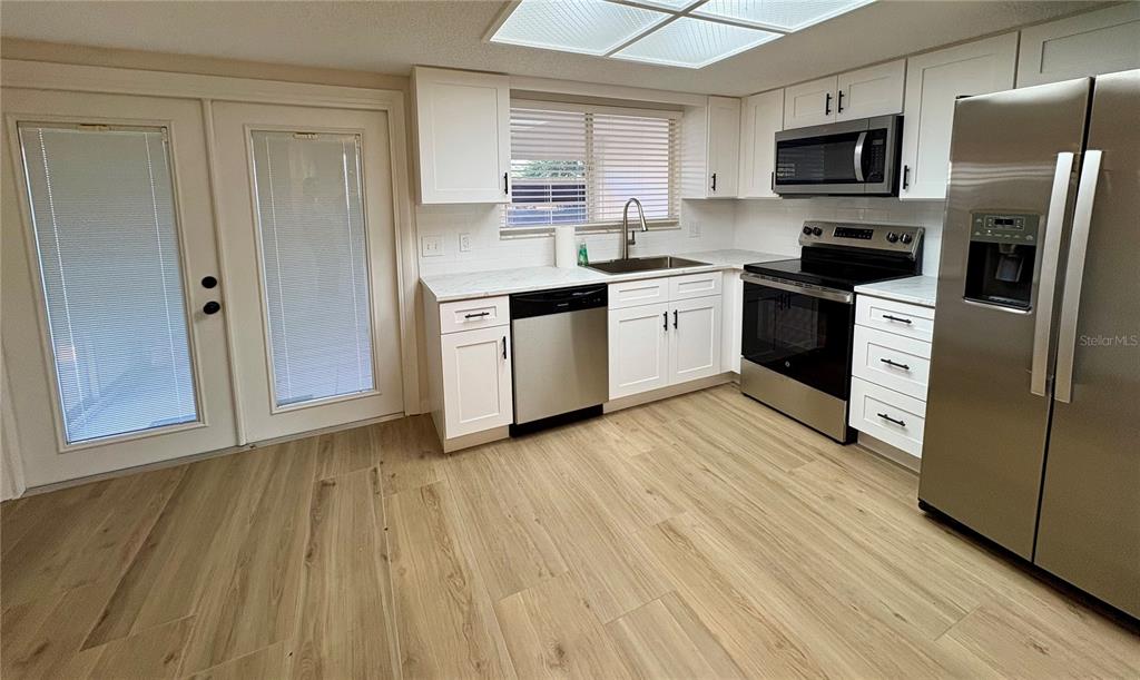 1455 Ridge Lake Court Lakeland, FL 33801 - Photo 6 of 15 a kitchen with stainless steel appliances a refrigerator sink and microwave