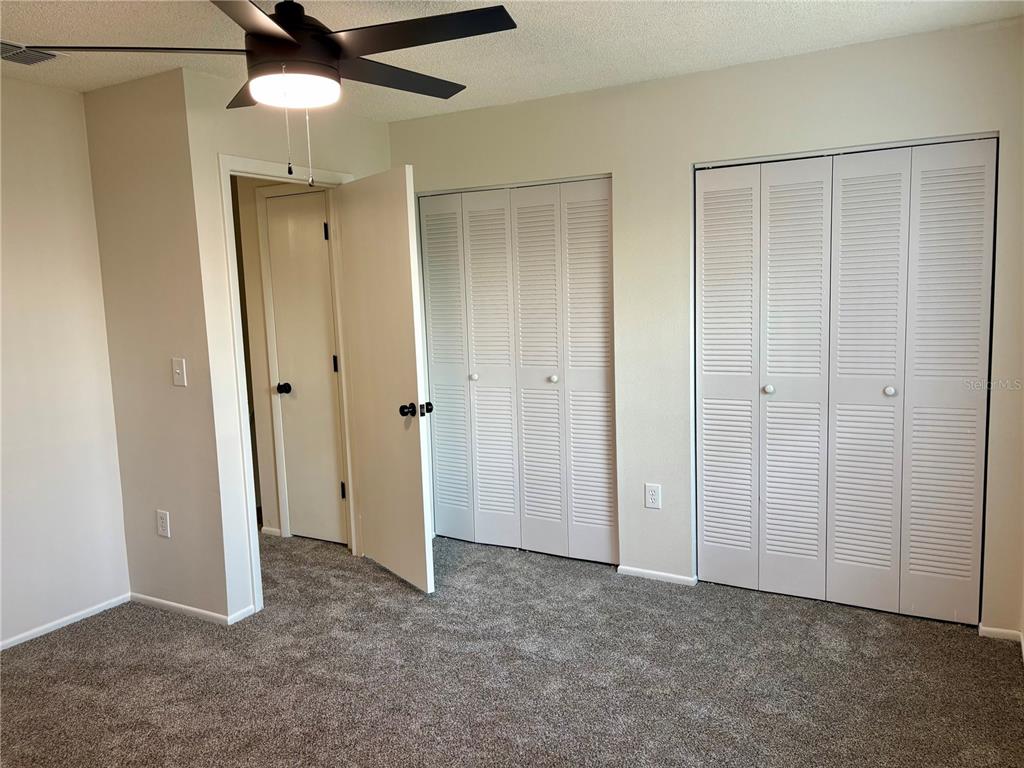 1455 Ridge Lake Court Lakeland, FL 33801 - Photo 9 of 15 an empty room with closet and a chandelier fan