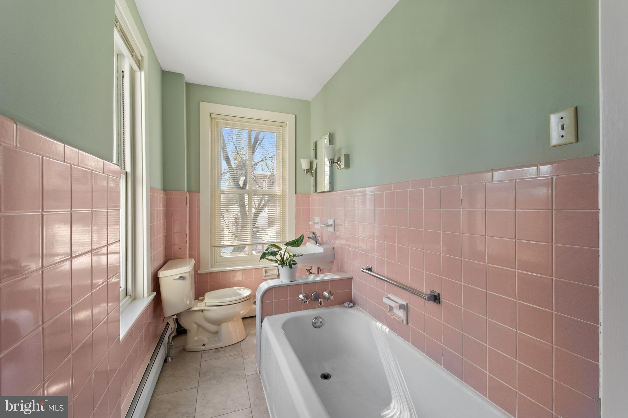 254 Chestnut Street Spring City, PA 19475 - Photo 26 of 37 a bathroom with a tub a sink and a large mirror next to a window