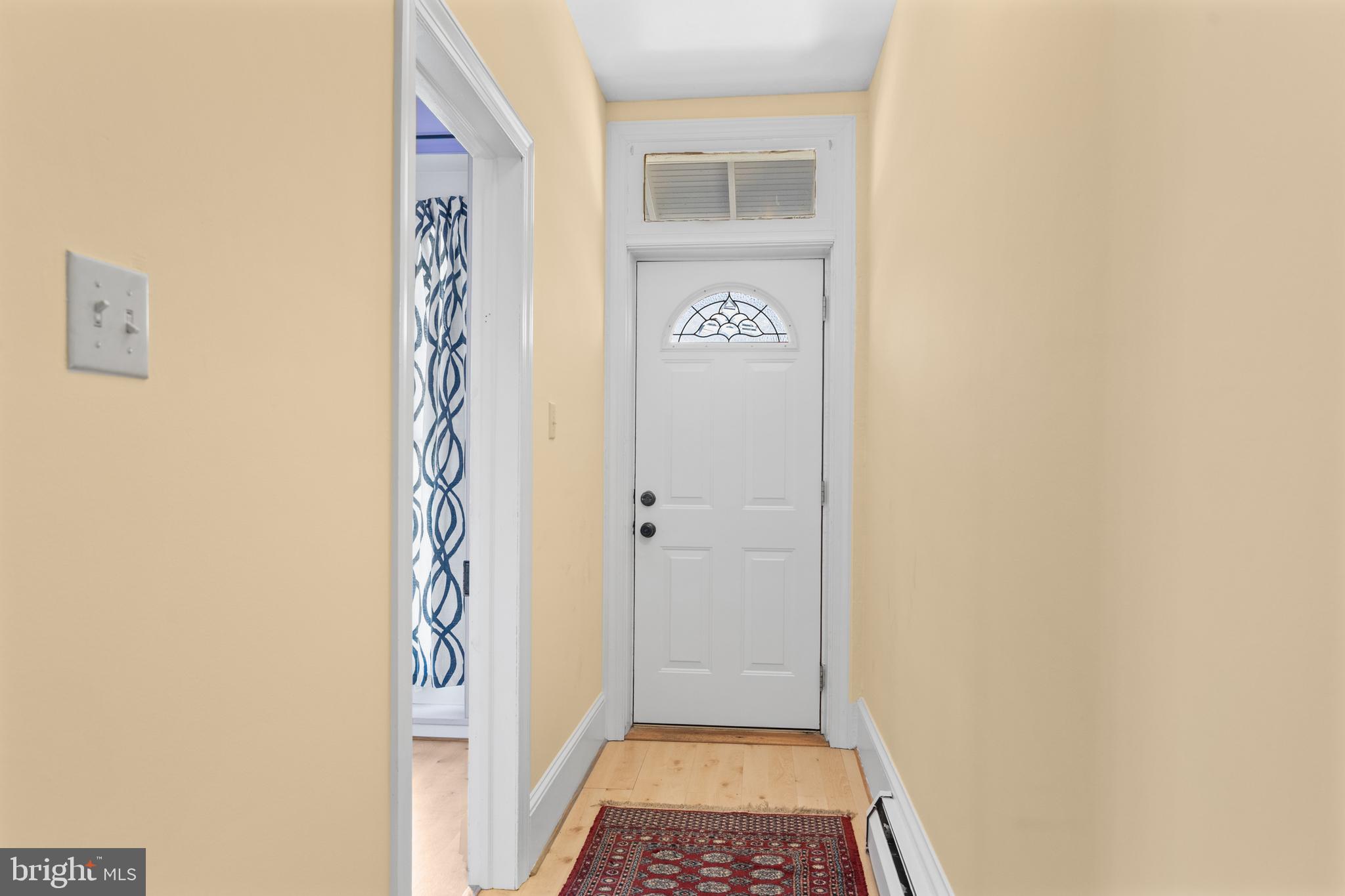254 Chestnut Street Spring City, PA 19475 - Photo 3 of 37 a view of a hallway with wooden floor and a bathroom