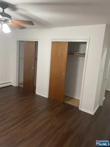 an empty room with wooden floor and closet