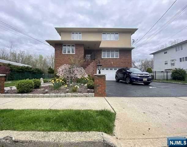 60 Maiden Lane, Unit 2 Little Ferry, NJ 07643 - Photo 22 of 22 a front view of a house with a yard