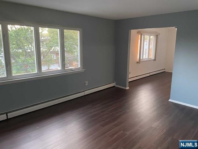 60 Maiden Lane, Unit 2 Little Ferry, NJ 07643 - Photo 3 of 22 an empty room with wooden floor and windows