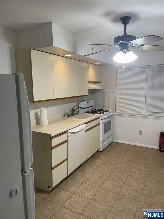 60 Maiden Lane, Unit 2 Little Ferry, NJ 07643 - Photo 4 of 22 a kitchen with stainless steel appliances a sink stove and cabinets