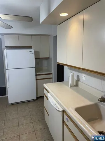 a kitchen with a refrigerator and a sink