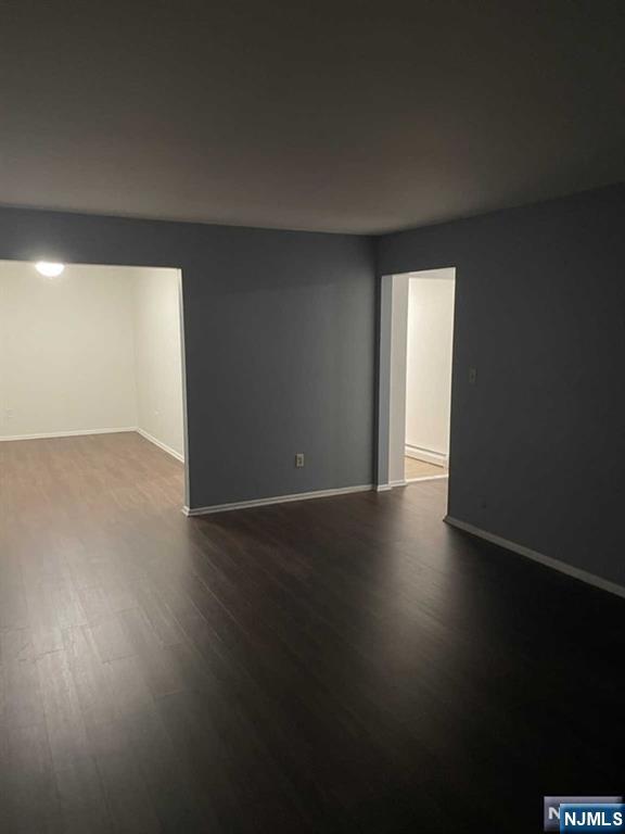 60 Maiden Lane, Unit 2 Little Ferry, NJ 07643 - Photo 9 of 22 a view of an empty room with wooden floor and a window
