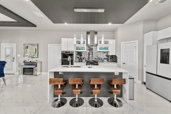 a large kitchen with a table and chairs