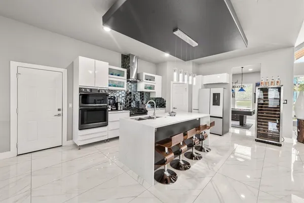 a kitchen with stainless steel appliances kitchen island granite countertop a stove and cabinets