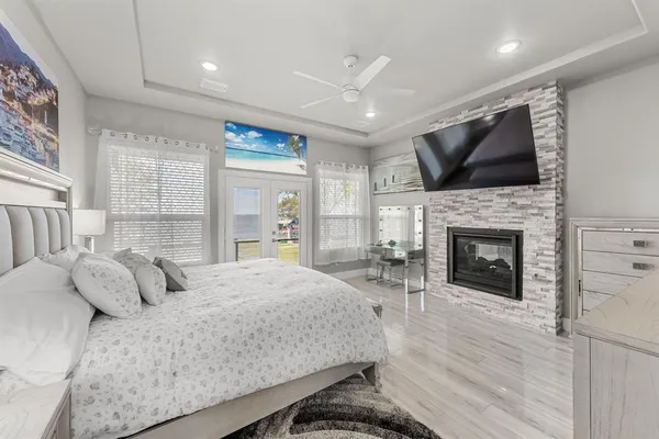 a bedroom with a large bed and a fireplace