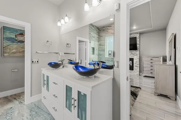 a kitchen with stainless steel appliances kitchen island granite countertop a refrigerator and a sink