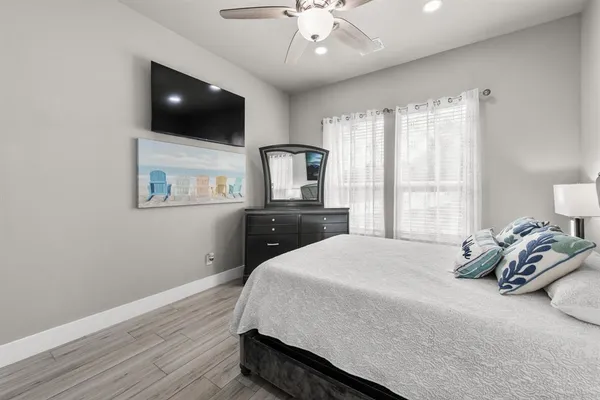 a bedroom with a bed and a flat screen tv