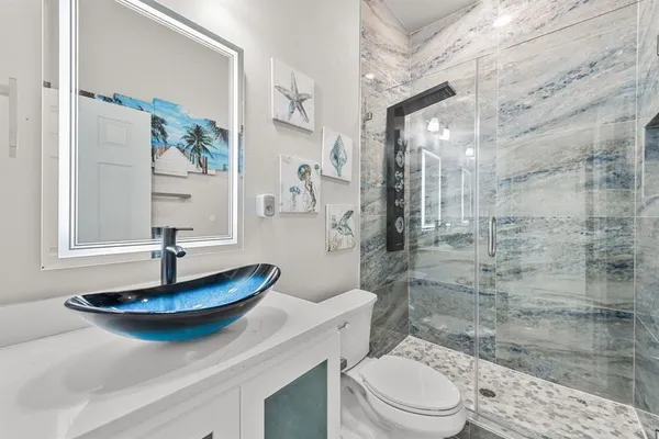 a bathroom with a sink a toilet and a mirror