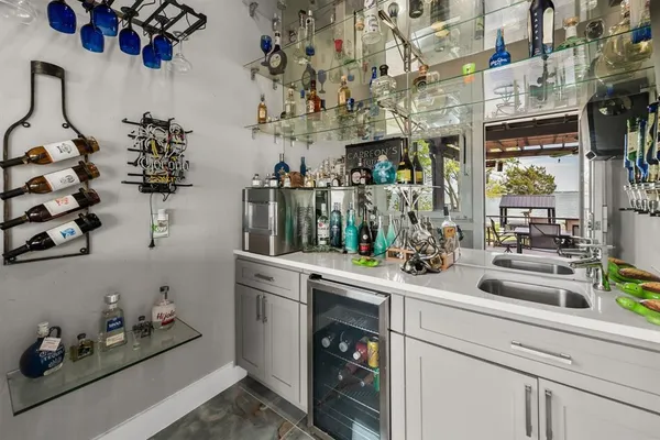 a kitchen with a sink a stove and cabinets