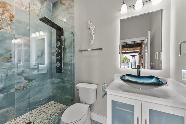 a bathroom with a sink toilet and shower