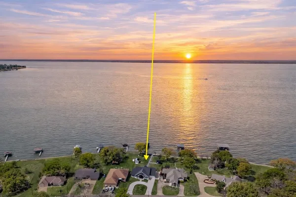a view of a lake with a floor to ceiling window