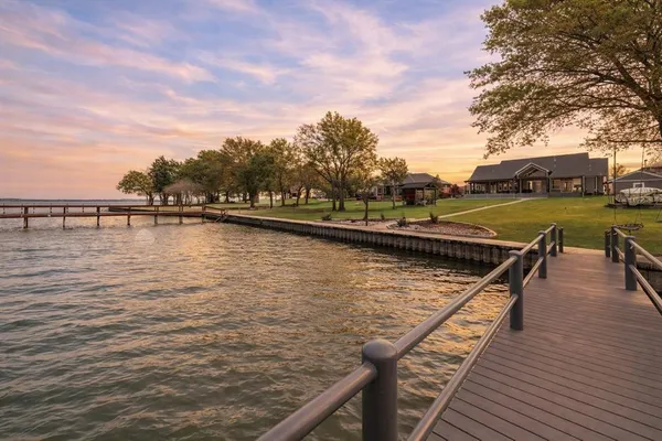 a view of swimming pool with outdoor seating and lake