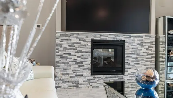 a living room with a fireplace and a flat screen tv