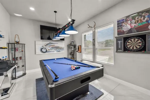 a room with pool table and flat screen tv