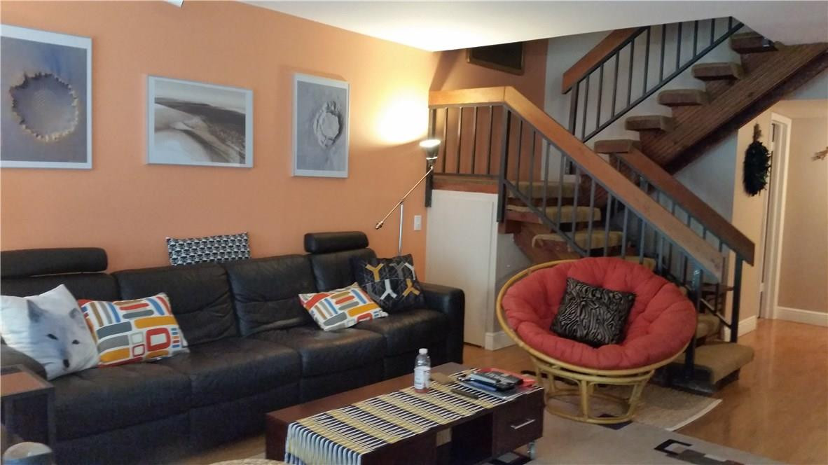 9711 North New River Canal Road, Unit 212 Plantation, FL 33324 - Photo 13 of 41 a living room with furniture and a painting