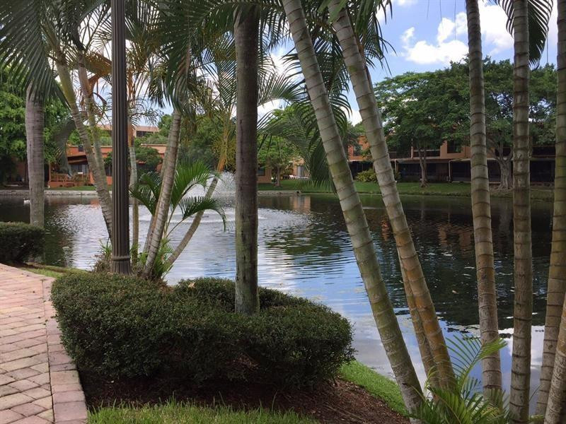 9711 North New River Canal Road, Unit 212 Plantation, FL 33324 - Photo 2 of 41 a lake view with outdoor seating